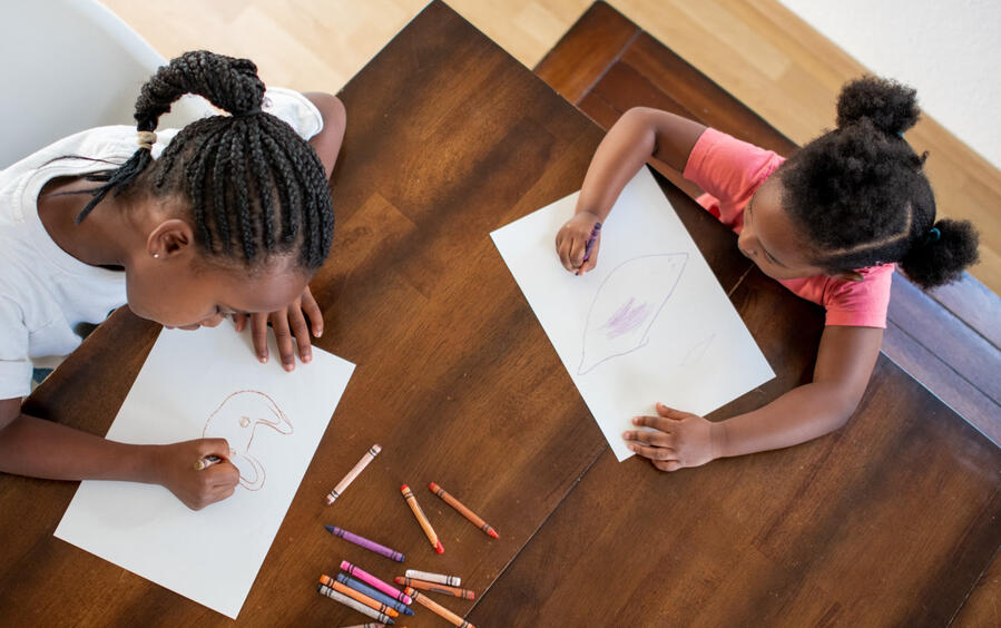 children coloring at a table